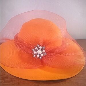 Elegant Orange Hat with Decorative Brooch